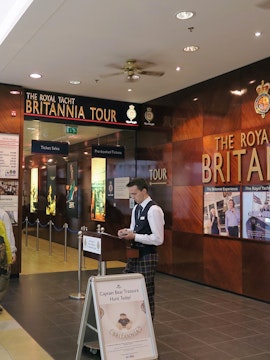Visitors entering The Royal Yacht Britannia tour entrance in Edinburgh.