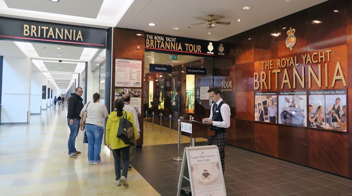 Visitors entering The Royal Yacht Britannia tour entrance in Edinburgh.