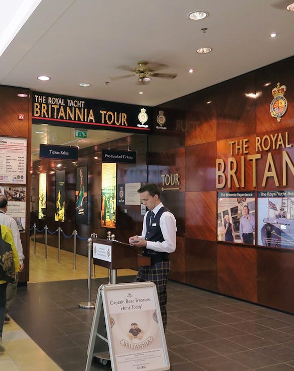 Visitors entering The Royal Yacht Britannia tour entrance in Edinburgh.