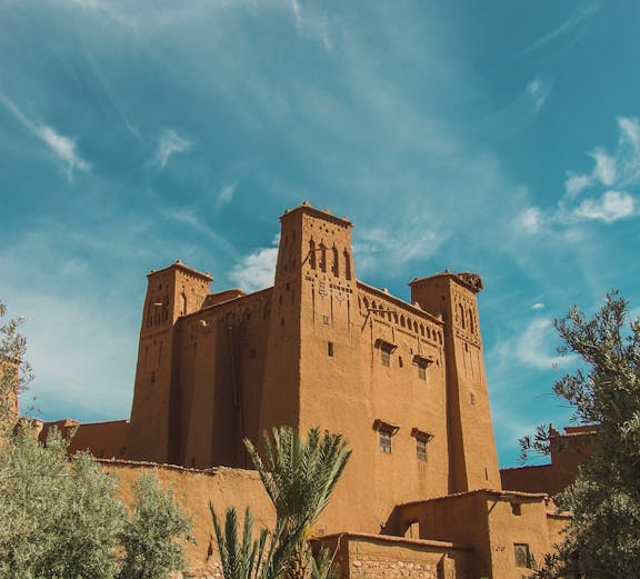 Ancient kasbah in Ouarzazate, Morocco, with clear blue sky.