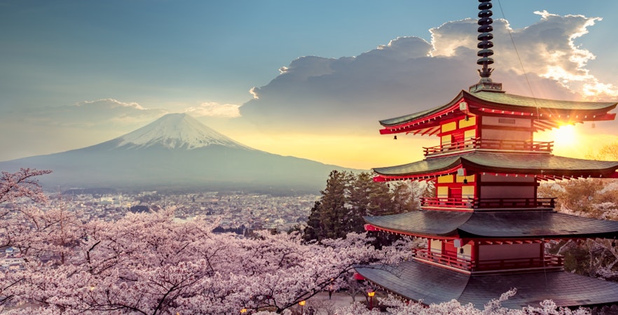 Chureito Pagoda with Mount Fuji and cherry blossoms at sunset in Fujiyoshida, Japan.