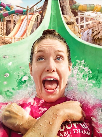 Person enjoying a water slide at Yas Waterworld, Abu Dhabi.