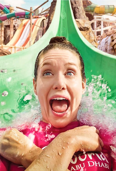 Person enjoying a water slide at Yas Waterworld, Abu Dhabi.