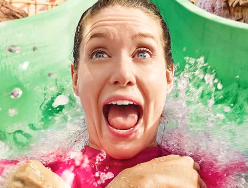 Person enjoying a water slide at Yas Waterworld, Abu Dhabi.