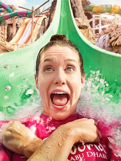 Person enjoying a water slide at Yas Waterworld, Abu Dhabi.
