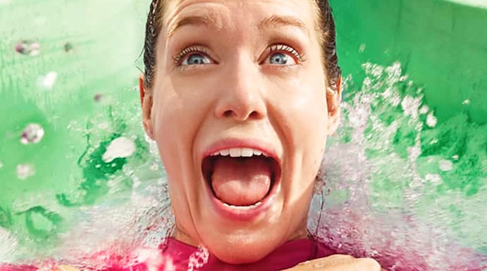 Person enjoying a water slide at Yas Waterworld, Abu Dhabi.