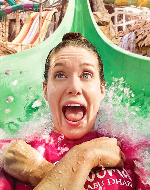 Person enjoying a water slide at Yas Waterworld, Abu Dhabi.