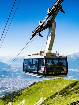 Hungerburg Funicular ascending over Innsbruck with mountain views.