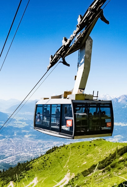Hungerburg Funicular ascending over Innsbruck with mountain views.