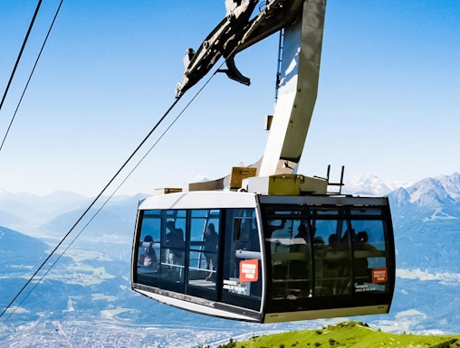 Hungerburg Funicular ascending over Innsbruck with mountain views.