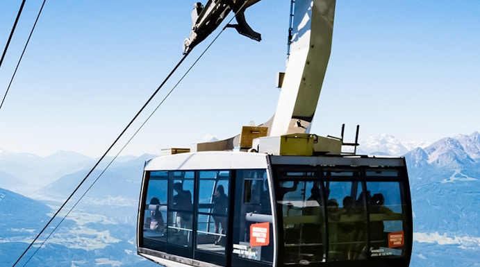 Hungerburg Funicular ascending over Innsbruck with mountain views.