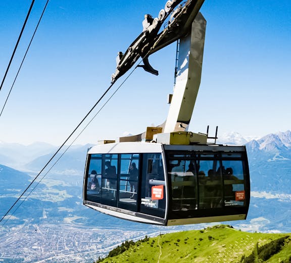 Hungerburg Funicular ascending over Innsbruck with mountain views.