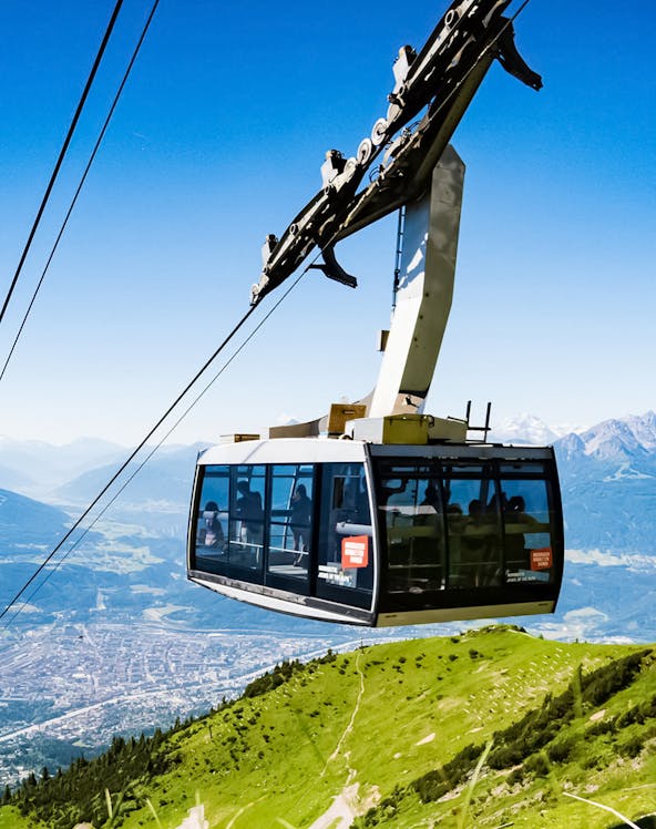 Hungerburg Funicular ascending over Innsbruck with mountain views.
