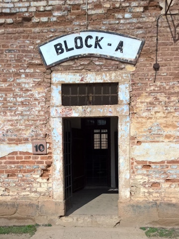 Entrance to Block A at Terezin Concentration Camp, showing weathered brick walls and open doorway.