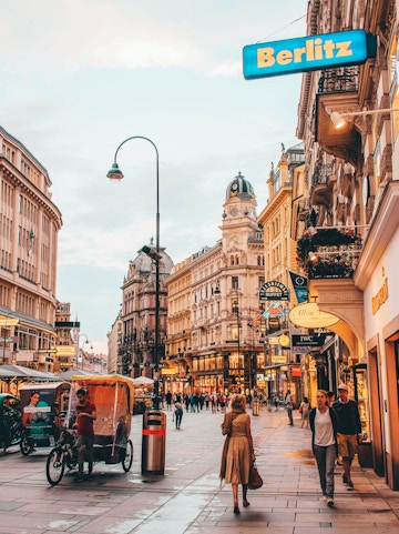 Vienna city street near Sigmund Freud Museum with people and historic buildings.
