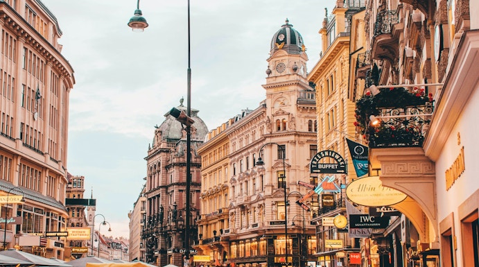 Vienna city street near Sigmund Freud Museum with people and historic buildings.