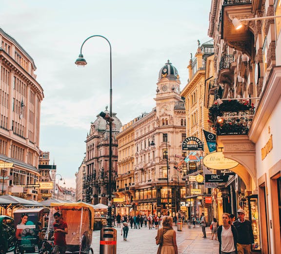 Vienna city street near Sigmund Freud Museum with people and historic buildings.