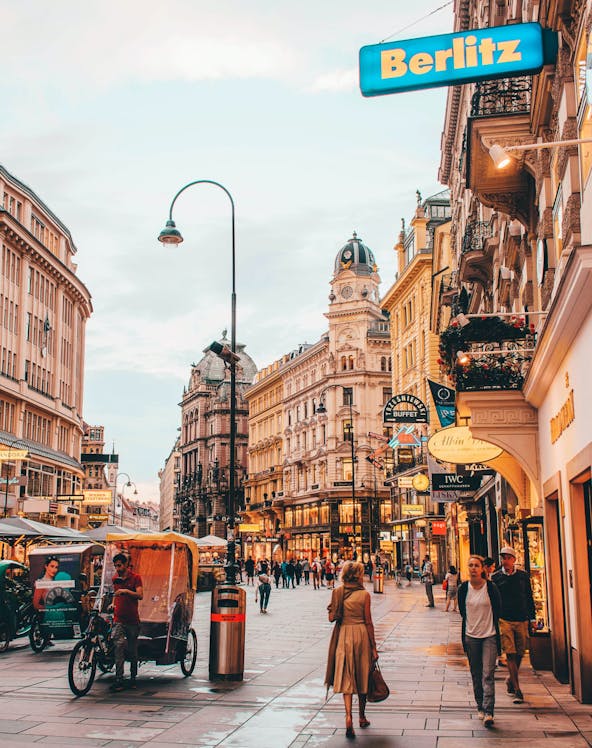 Vienna city street near Sigmund Freud Museum with people and historic buildings.