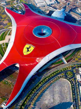 Ferrari World Abu Dhabi aerial view, featuring iconic red roof and surrounding attractions.