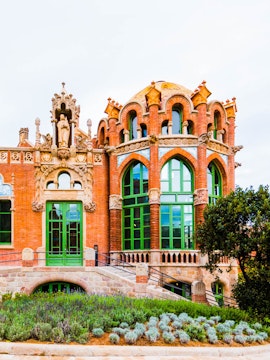 Recinto Modernista de Sant Pau building with ornate arches and green windows in Barcelona.