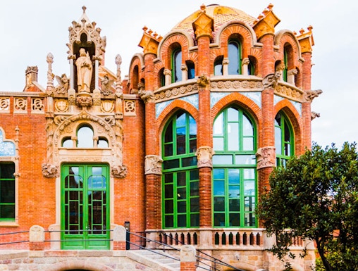 Recinto Modernista de Sant Pau building with ornate arches and green windows in Barcelona.