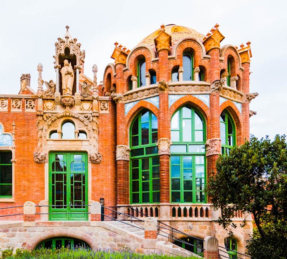 Recinto Modernista de Sant Pau building with ornate arches and green windows in Barcelona.
