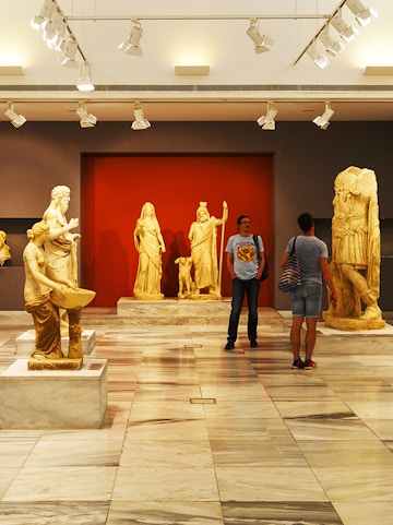 Heraklion Archeological Museum interior with ancient Greek statues on display.