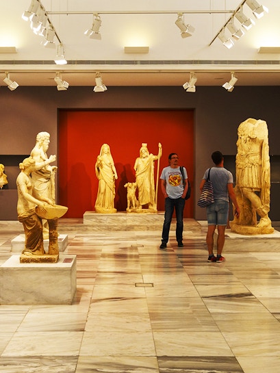 Heraklion Archeological Museum interior with ancient Greek statues on display.