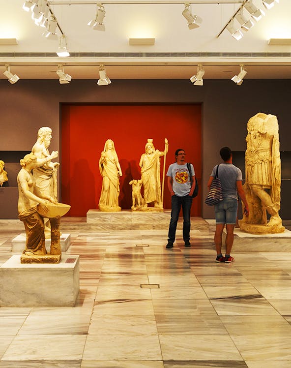 Heraklion Archeological Museum interior with ancient Greek statues on display.