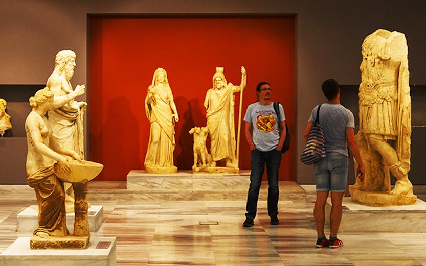 Heraklion Archeological Museum interior with ancient Greek statues on display.