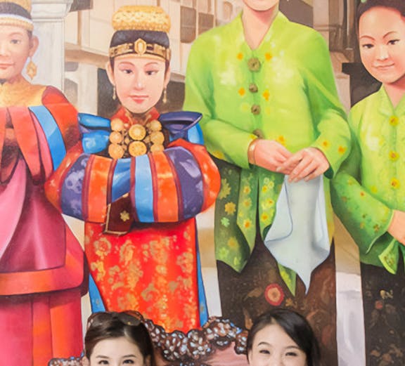 Visitors posing with vibrant cultural murals at MagicArt 3D Museum, Melaka.
