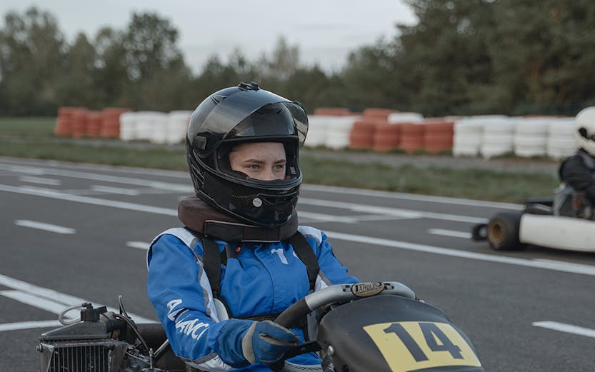 Go-kart racer in blue suit at Morac Adventure Park, Langkawi track.