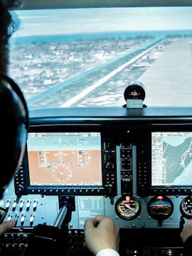 Flight simulator cockpit view during approach, Aero-aviation experience in Singapore.