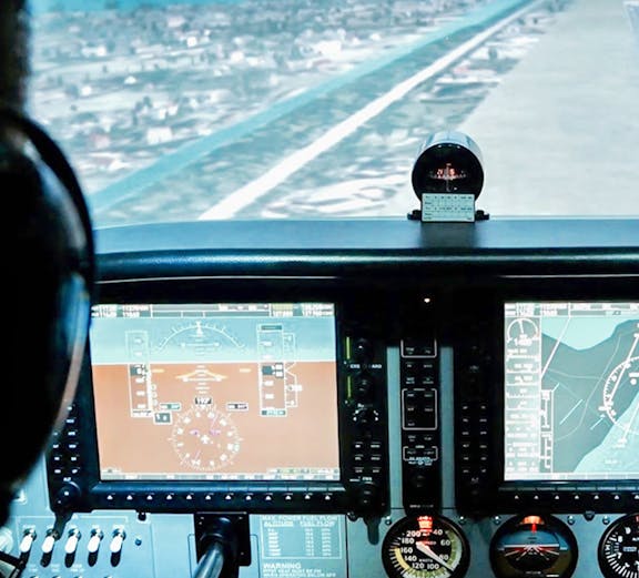 Flight simulator cockpit view during approach, Aero-aviation experience in Singapore.