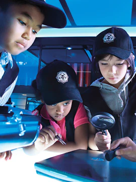 Children engaging in a detective activity at Kidzania Kuala Lumpur.