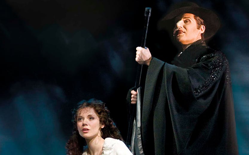 Two performers in a dramatic scene from a classic theater show.