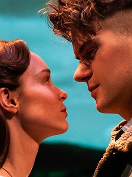 Actors in an intimate scene from a romantic Broadway show.