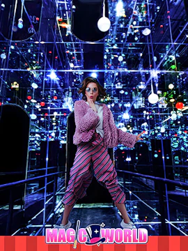 Visitor in mirrored room with colorful lights at Magic World Penang.