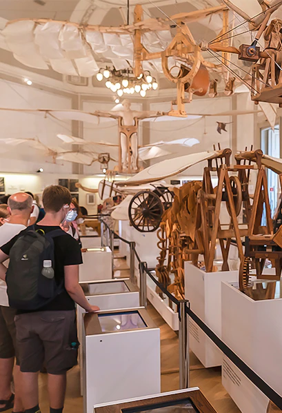 Visitors viewing Leonardo da Vinci's flying machine models at Leonardo3 Museum.