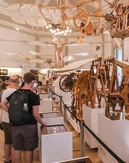 Visitors viewing Leonardo da Vinci's flying machine models at Leonardo3 Museum.