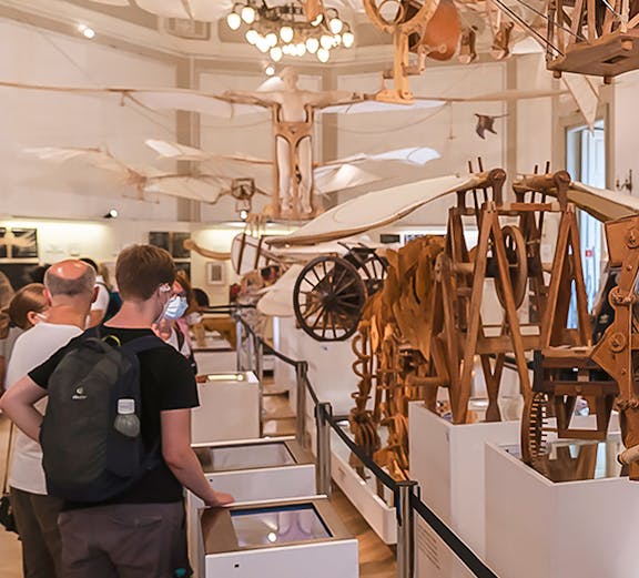 Visitors viewing Leonardo da Vinci's flying machine models at Leonardo3 Museum.