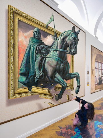 Illusion Art Museum visitor interacts with 3D painting of a knight on horseback.