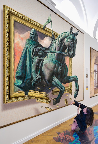 Illusion Art Museum visitor interacts with 3D painting of a knight on horseback.