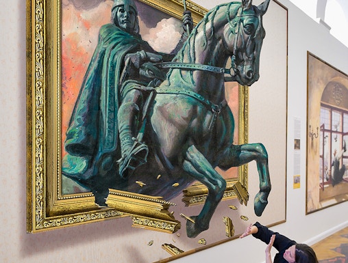 Illusion Art Museum visitor interacts with 3D painting of a knight on horseback.