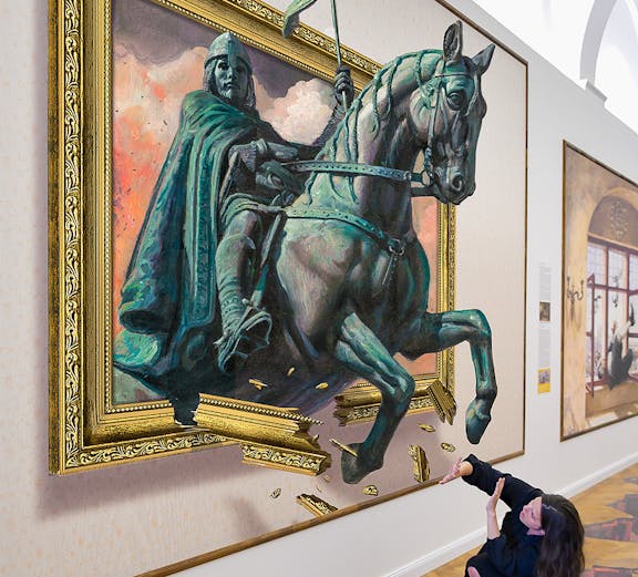Illusion Art Museum visitor interacts with 3D painting of a knight on horseback.