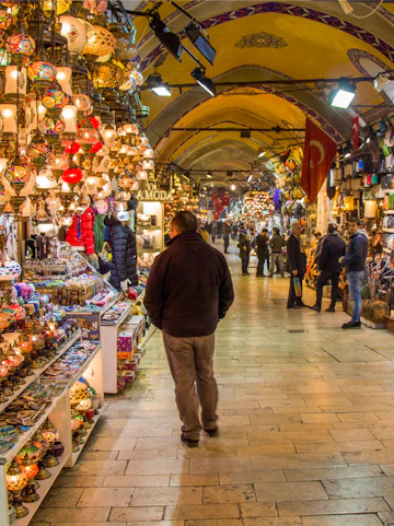 Shoppers exploring vibrant stalls in Istanbul's Grand Bazaar.