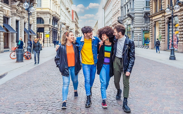 Tourists walking on a street in Milan during a city tour.