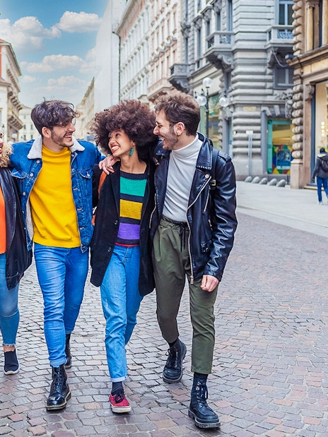 Tourists walking on a street in Milan during a city tour.