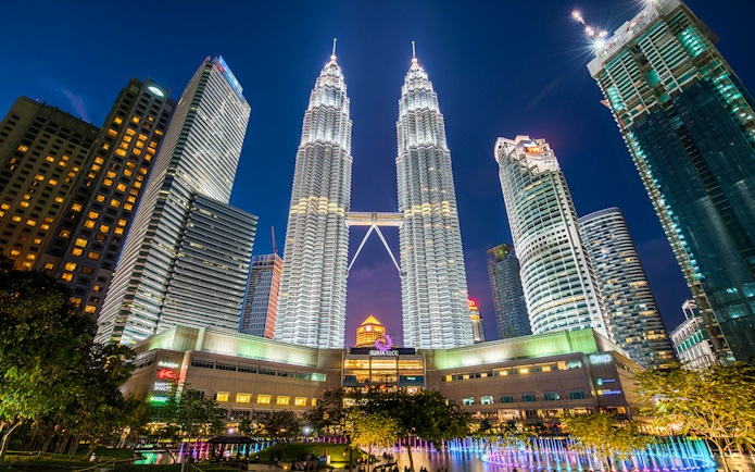 Petronas Twin Towers illuminated at night in Kuala Lumpur, Malaysia.