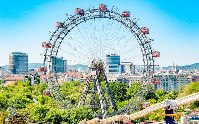 Ferris Wheel Riesenrad in Prater, Vienna with cityscape in background.